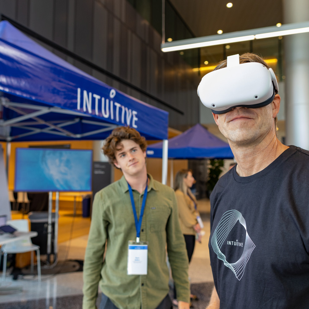 Intuitive employees at a marketing event wearing VR head set