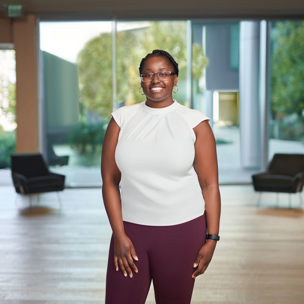 Analyst team member posing in front of background