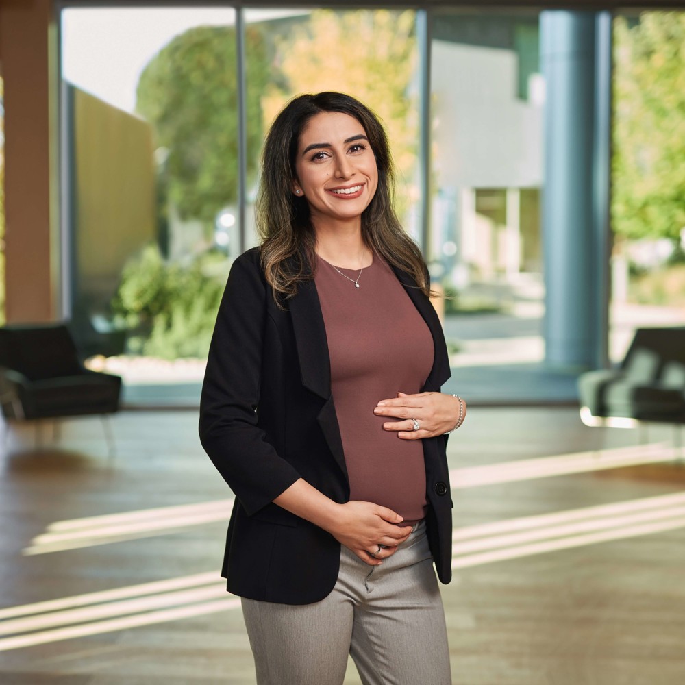 Sahar Ibarra, Manufacturing Engineer, pregnant and posing in front of camera