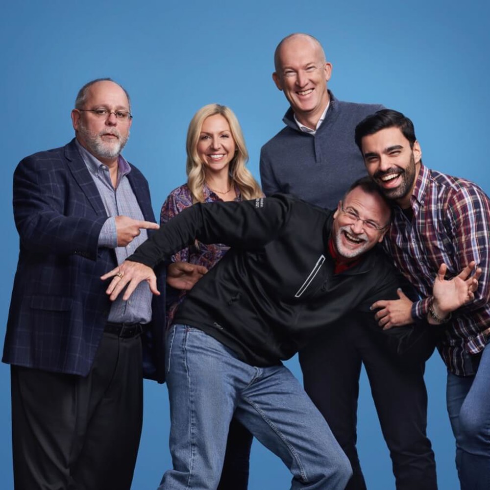 HR employees grouped together with a blue background - Who we are mast image