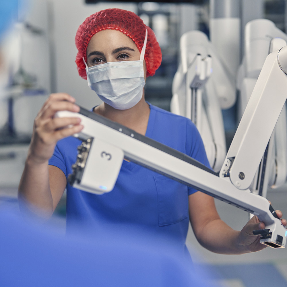 Surgeon installing a da Vinci arm into the multiport system