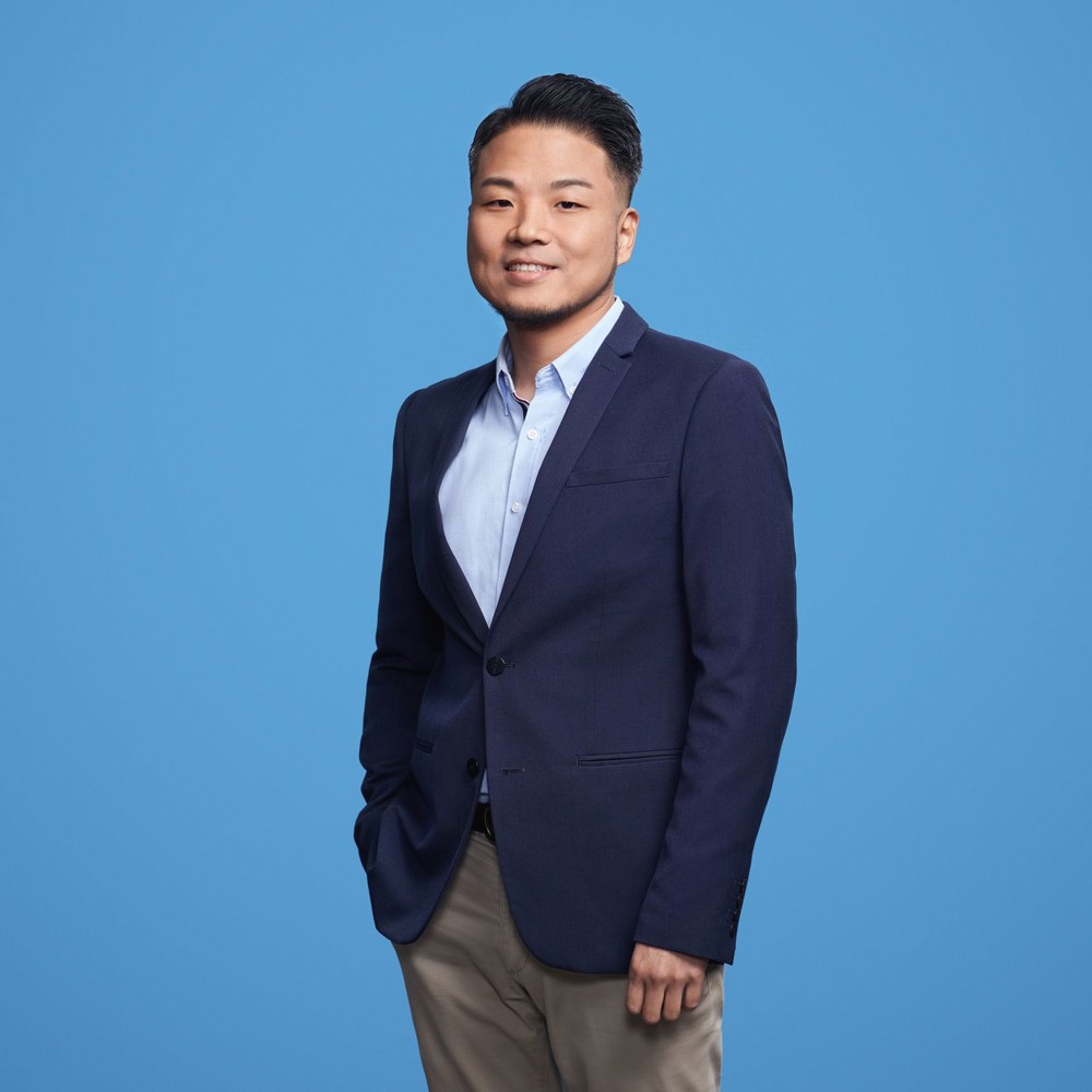 Security Engineer standing in front of light blue background